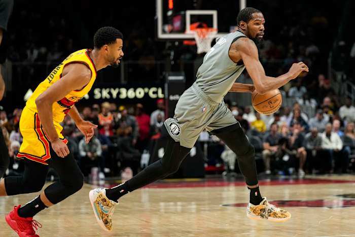 Apr 2, 2022; Atlanta, Georgia, USA; Brooklyn Nets forward Kevin Durant (7) dribbles past Atlanta Hawks guard Timothe Luwawu-Cabarrot (7) during the first quarter at State Farm Arena.